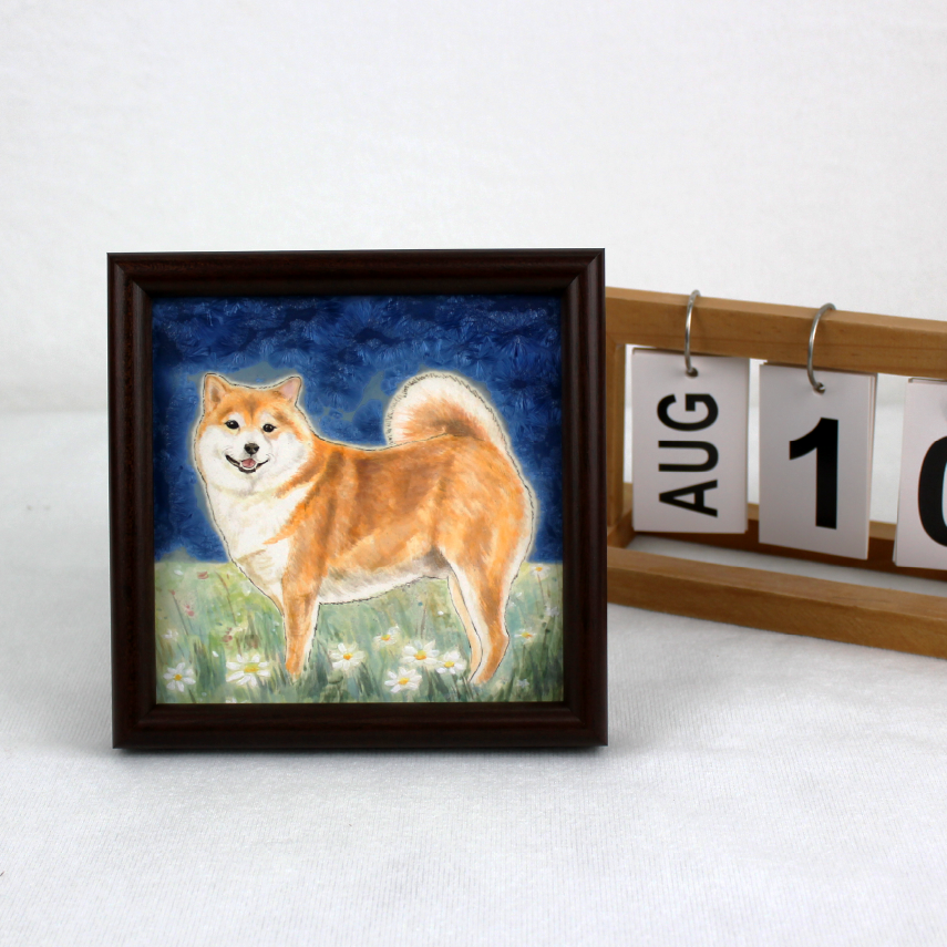 Custom ceramic portraits of cat and dog displayed together