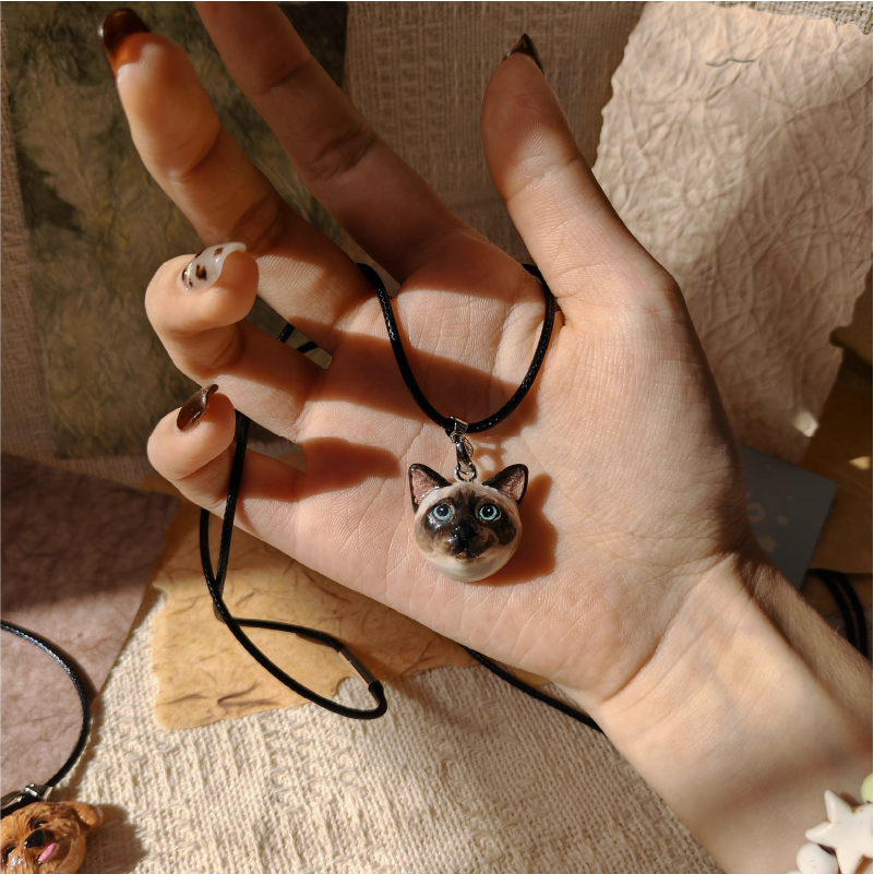 Personalized pet plaster necklace shown in hand close-up